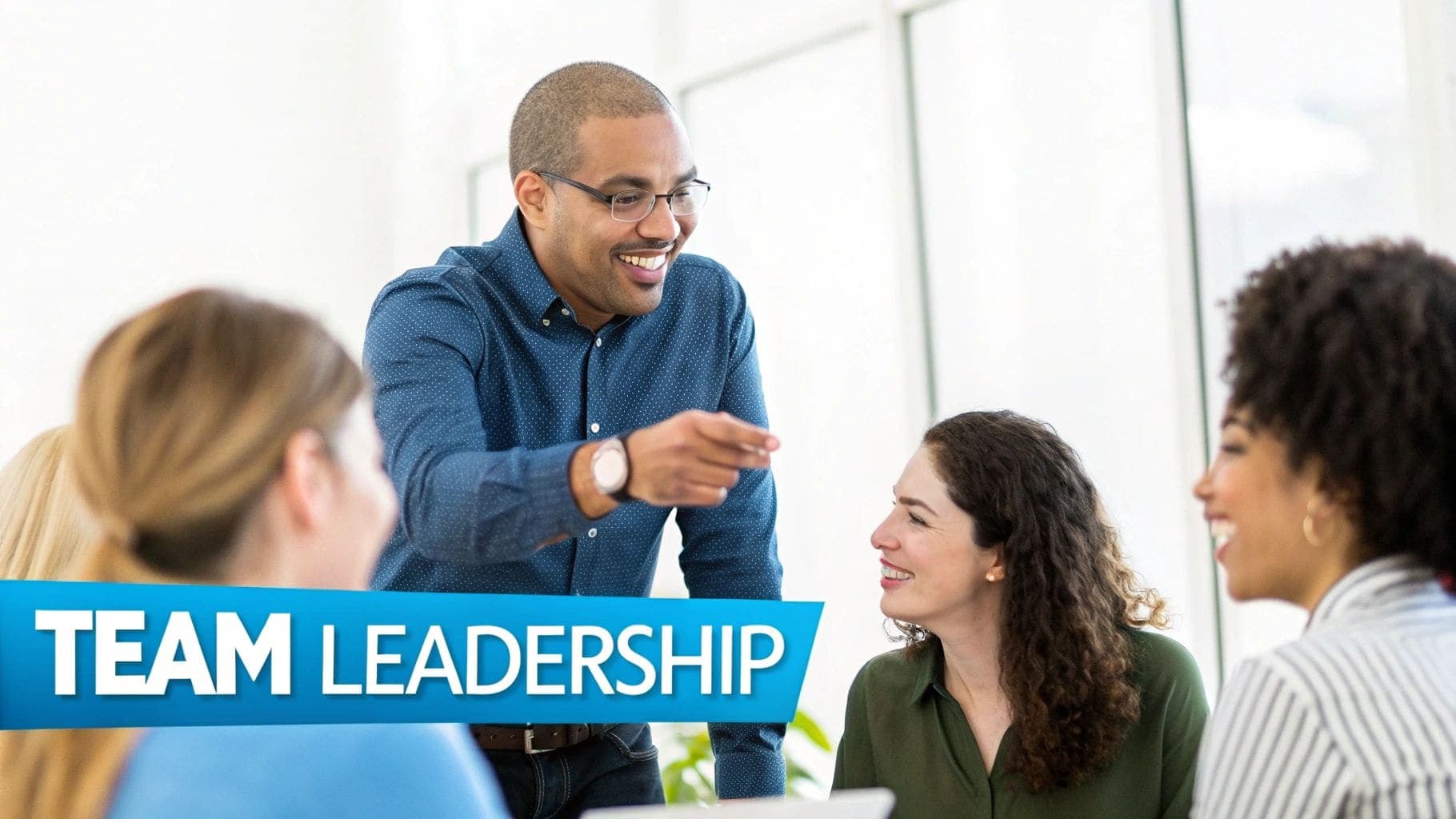 Professional man wearing glasses leading smiling diverse team pointing during collaborative discussion about leadership and team management in modern office setting